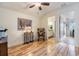 Bedroom featuring light hardwood flooring and an open door to the adjoining bathroom at 19312 Sunset Bay Dr, Land O Lakes, FL 34638