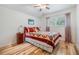 Bedroom featuring hardwood floors and a window view at 19312 Sunset Bay Dr, Land O Lakes, FL 34638