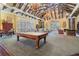 Spacious clubhouse interior featuring a pool table, dining area, and cozy seating with elegant lighting at 19312 Sunset Bay Dr, Land O Lakes, FL 34638
