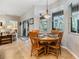 The dining area includes a wood table, chairs, views of the backyard and access to living area at 19312 Sunset Bay Dr, Land O Lakes, FL 34638