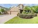 Well-maintained home with a three-car garage, brick-paved driveway, and attractive landscaping at 19312 Sunset Bay Dr, Land O Lakes, FL 34638