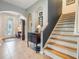 Welcoming foyer with tile flooring, staircase, and traditional decor creates a warm ambiance at 19312 Sunset Bay Dr, Land O Lakes, FL 34638