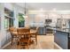 Kitchen showcasing stainless appliances, white and gray cabinets, decorative backsplash, and access to the breakfast table at 19312 Sunset Bay Dr, Land O Lakes, FL 34638