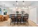 Bright kitchen with stainless steel appliances, two-tone cabinets, tile backsplash, island with seating, and easy access to the dining area at 19312 Sunset Bay Dr, Land O Lakes, FL 34638