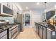 Modern kitchen featuring stainless appliances, white and gray cabinets, tile backsplash, ample countertop space, and open layout at 19312 Sunset Bay Dr, Land O Lakes, FL 34638
