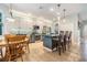 Bright kitchen featuring stainless appliances, white and gray cabinets, tile backsplash, island with barstool seating, and a breakfast table at 19312 Sunset Bay Dr, Land O Lakes, FL 34638
