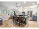 Bright kitchen with stainless steel appliances, two-tone cabinets, tile backsplash, island with bar seating, and tile floors at 19312 Sunset Bay Dr, Land O Lakes, FL 34638