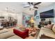 Open living room with comfortable seating, a modern ceiling fan, and access to the kitchen at 19312 Sunset Bay Dr, Land O Lakes, FL 34638