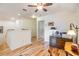 Bright loft features wood floors, a ceiling fan and a desk with vintage-inspired decor at 19312 Sunset Bay Dr, Land O Lakes, FL 34638