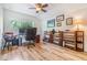 Well-lit office features wood floors, a ceiling fan and a large window overlooking greenery at 19312 Sunset Bay Dr, Land O Lakes, FL 34638