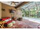 Screened in patio features a fire pit and outdoor furniture near pool area at 19312 Sunset Bay Dr, Land O Lakes, FL 34638