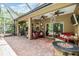 Spacious screened in patio with fire pit, fan, grill, and outdoor dining at 19312 Sunset Bay Dr, Land O Lakes, FL 34638