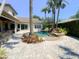Backyard oasis with lush landscaping, pool, spa, and an outdoor kitchen under a covered patio at 2041 Gold Dust Ct, Trinity, FL 34655