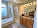Bright bathroom featuring soaking tub, glass enclosed shower, and double sink vanity at 2041 Gold Dust Ct, Trinity, FL 34655