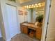 Bathroom featuring large vanity and a large mirror with decorative lighting at 2041 Gold Dust Ct, Trinity, FL 34655