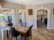 Elegant dining room with a marble table, leather chairs, and views of the outdoor living space at 2041 Gold Dust Ct, Trinity, FL 34655