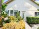 Exterior view of the home and gardens with vibrant vegetation including flowers, trees, and bushes at 2041 Gold Dust Ct, Trinity, FL 34655