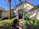 Charming front exterior with a stone facade, arched entrance, and manicured landscaping at 2041 Gold Dust Ct, Trinity, FL 34655