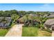 Aerial view of the property showcasing the well-manicured lawn and palm tree landscaping at 2041 Gold Dust Ct, Trinity, FL 34655