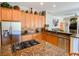 Well-equipped kitchen featuring stainless steel appliances, granite countertops, a central island, and generous cabinet space at 2041 Gold Dust Ct, Trinity, FL 34655