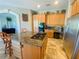 Spacious kitchen with granite countertops, stainless steel appliances, an island cooktop, and custom cabinets at 2041 Gold Dust Ct, Trinity, FL 34655