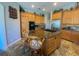 The kitchen features granite countertops, stainless steel appliances, custom cabinetry, and an island with seating at 2041 Gold Dust Ct, Trinity, FL 34655