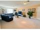 Spacious living room with ample lighting, comfortable seating, and a TV, creating an inviting space at 2041 Gold Dust Ct, Trinity, FL 34655