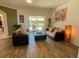 Inviting living room with wood floors, comfortable seating, and sliding doors to the outdoor patio at 2041 Gold Dust Ct, Trinity, FL 34655