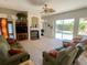Bright living room with a fireplace and sliding door access to the pool at 2041 Gold Dust Ct, Trinity, FL 34655