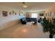 Spacious living room with ample lighting, comfortable seating, and a TV, creating an inviting space at 2041 Gold Dust Ct, Trinity, FL 34655