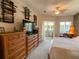 Bedroom featuring multiple dressers and a patio view. Decorative swords on the wall at 2041 Gold Dust Ct, Trinity, FL 34655