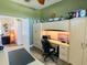 Office space with hardwood floors, large built-in desk with a rolling chair, shelving and natural light at 2041 Gold Dust Ct, Trinity, FL 34655