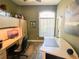 Office space with hardwood floors, large built-in desk with a rolling chair, shelving and natural light at 2041 Gold Dust Ct, Trinity, FL 34655