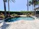 Inviting backyard swimming pool with rock waterfall feature and mature landscaping for privacy at 2041 Gold Dust Ct, Trinity, FL 34655