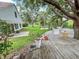 Large backyard features a deck, fire pit area, and lush green space at 22443 Crows Nest Ct, Lutz, FL 33549