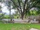 Spacious backyard with a large wooden deck, featuring a built-in tree swing and grilling area at 22443 Crows Nest Ct, Lutz, FL 33549