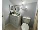 Bathroom featuring gray walls, white vanity, a toilet and modern lighting at 22443 Crows Nest Ct, Lutz, FL 33549