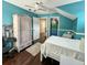 Bedroom featuring blue walls, hardwood floors, walk in closet and a ceiling fan at 22443 Crows Nest Ct, Lutz, FL 33549