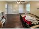 Bedroom featuring a ceiling fan, wood floors, with an exterior view from the window at 22443 Crows Nest Ct, Lutz, FL 33549