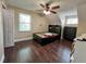 Bedroom featuring dark wood floors, black furniture, ceiling fan and natural light at 22443 Crows Nest Ct, Lutz, FL 33549