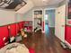 Bedroom featuring hardwood floors, red accent wall, a gray accent wall and walk in closet at 22443 Crows Nest Ct, Lutz, FL 33549