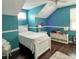 A bedroom with blue walls, hardwood floors, and a ceiling fan at 22443 Crows Nest Ct, Lutz, FL 33549