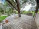 Relaxing outdoor deck with a hammock swing and mature trees providing shade at 22443 Crows Nest Ct, Lutz, FL 33549