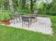 Paver patio featuring an inviting fire pit with seating and surrounded by a well-manicured lawn at 22443 Crows Nest Ct, Lutz, FL 33549