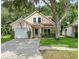Lovely two-story home with a well-manicured lawn and mature trees at 22443 Crows Nest Ct, Lutz, FL 33549