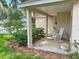 Charming front porch with a rocking chair and well-maintained landscaping at 22443 Crows Nest Ct, Lutz, FL 33549