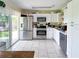 Galley kitchen featuring stainless steel appliances, and ample cabinet space, with sliding door access at 22443 Crows Nest Ct, Lutz, FL 33549