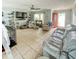 Spacious living room with tile floors, comfortable seating, a ceiling fan, and direct access to the outside at 22443 Crows Nest Ct, Lutz, FL 33549