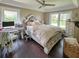 Inviting main bedroom featuring a tray ceiling, hardwood floors, and natural light at 22443 Crows Nest Ct, Lutz, FL 33549