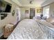 Serene main bedroom featuring a tray ceiling, hardwood floors, and a ceiling fan at 22443 Crows Nest Ct, Lutz, FL 33549